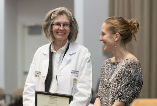 Vicky Fraser, MD, receives an award.