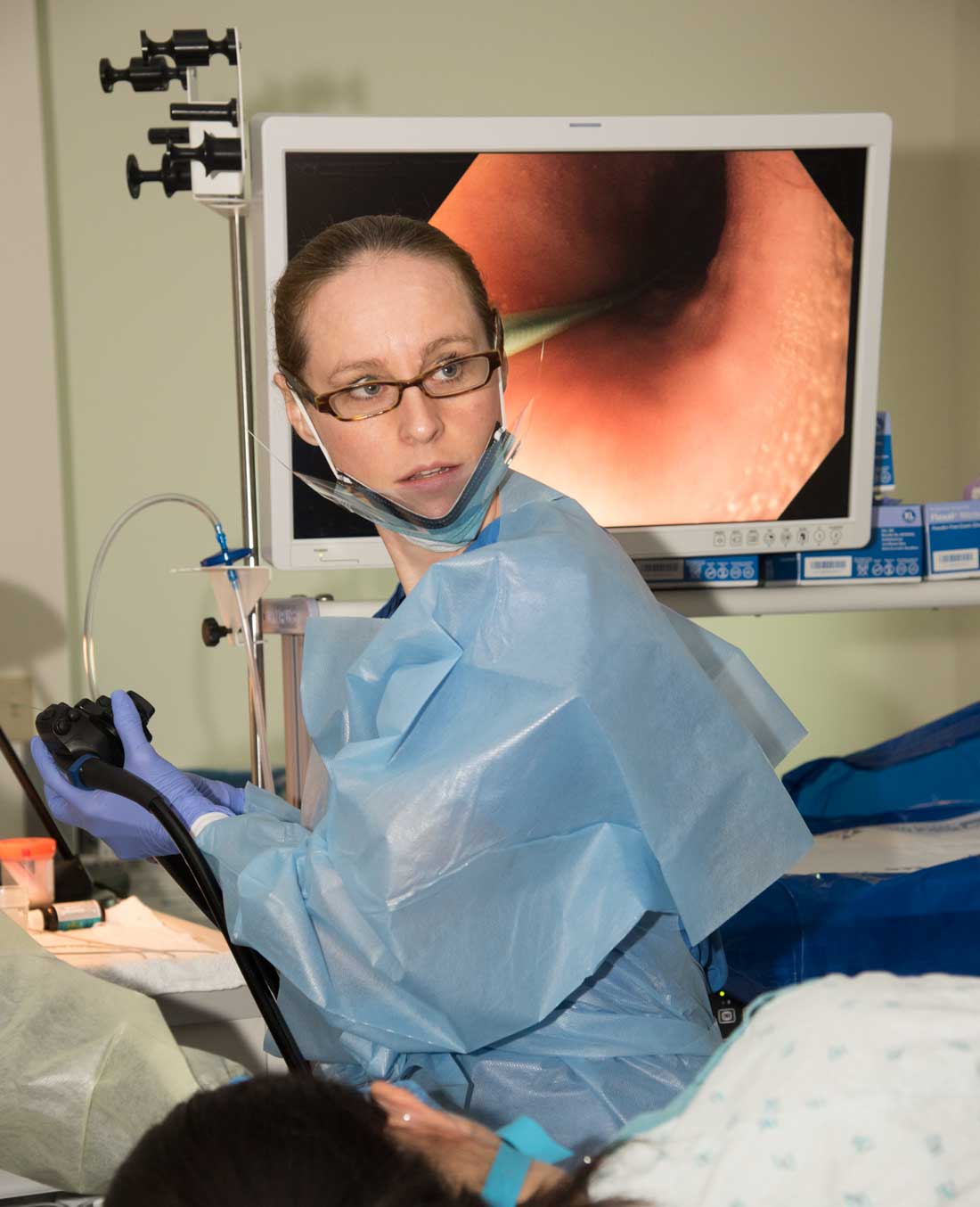 Shelby Sullivan, MD, inserts an endoscope into the mouth of a patient, routing a balloon to the stomach. There it is inflated to give the patient the feeling of being full after eating.