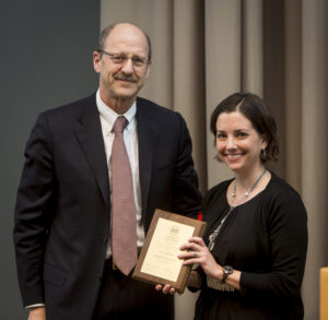 David H. Perlmutter, MD, executive vice chancellor for medical affairs and dean of the School of Medicine, awards Kelly R. Monk, PhD, the Distinguished Investigator Award.