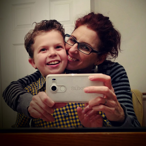 Carmen Valero-Aracama and her son, Luca, smile for a selfie.