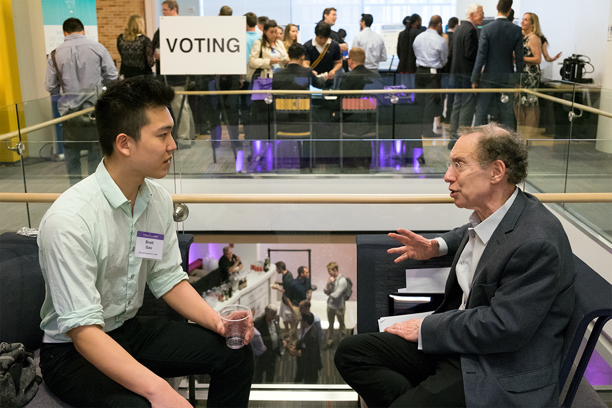 Brett Gao, an undergraduate student in biochemistry and engineering, talks with well-known entrepreneur Robert Langer, of MIT, before Langer's keynote speech at the IDEA Labs "Demo Day" event April 25.