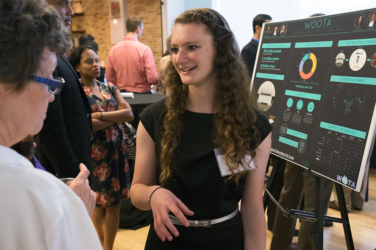 Sydney Katz, an undergraduate student in electrical engineering, talks with IDEA Labs "Demo Day" participants about her team's technology, which aims to alleviate the clean-water crisis in developing countries.