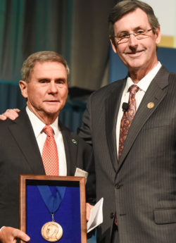 Ralph G. Dacey, Jr., MD (left) receives the Cushing Medal from AANS then-president H. Hunt Batjer.