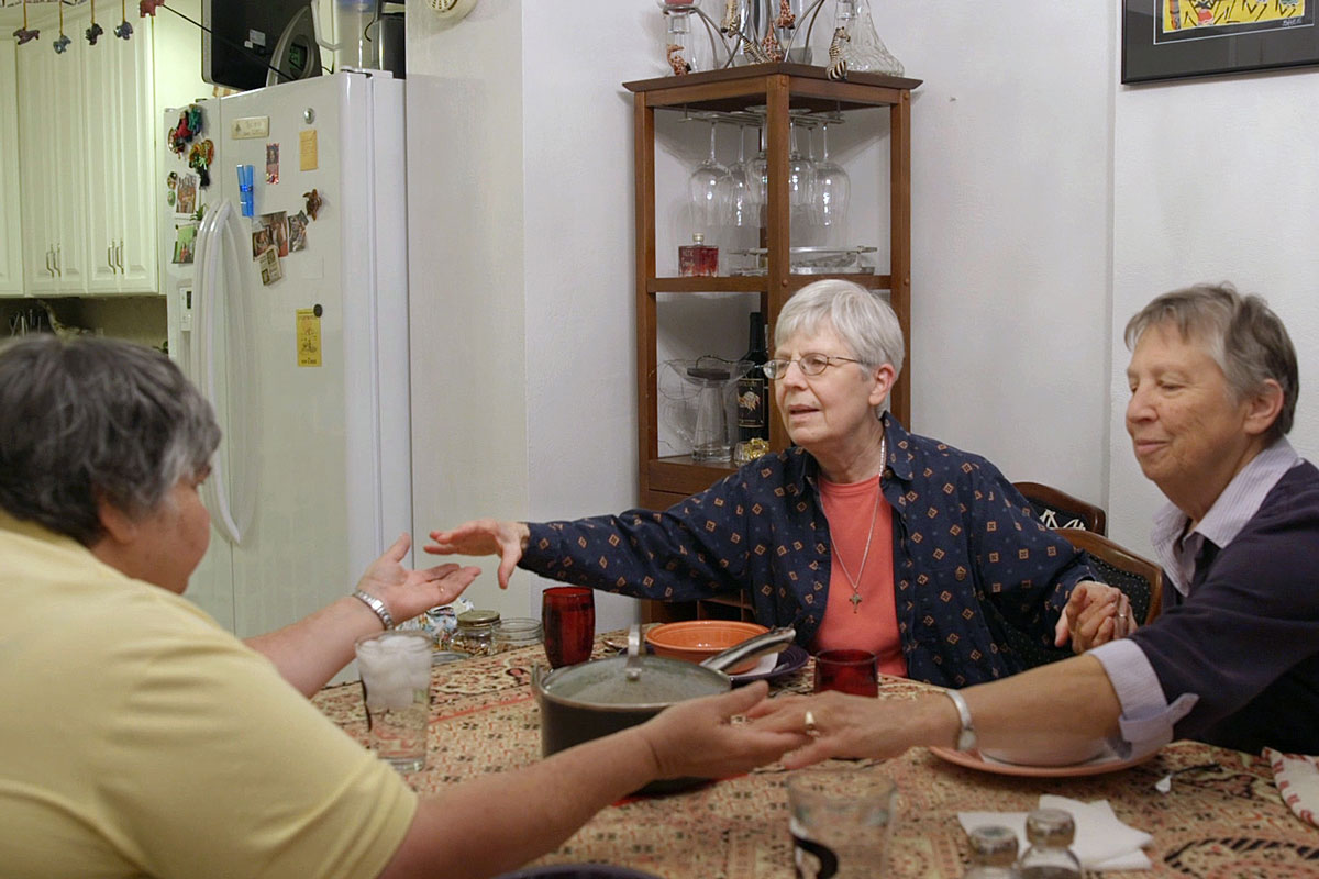 Sister Barbara Schlatter (center) says a prayer before dinner with Sister Toni Temporiti (left) and Sister Lucy Meissen at their home in St. Louis. Schlatter is a participant in the Adult Children Study at Washington University School of Medicine in St. Louis.