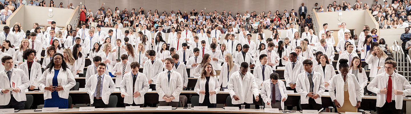 The incoming class of 124 medical students pledges an oath wearing their newly received white coats