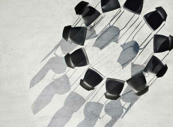 11 black chairs form a circle