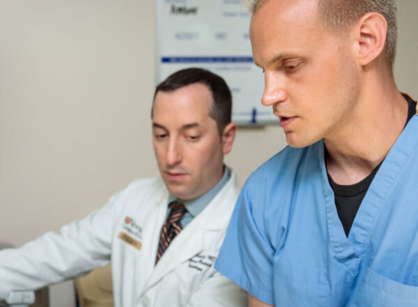 Medical student Weston McCarron (right), practices performing an ultrasound with Evan Schwarz, MD