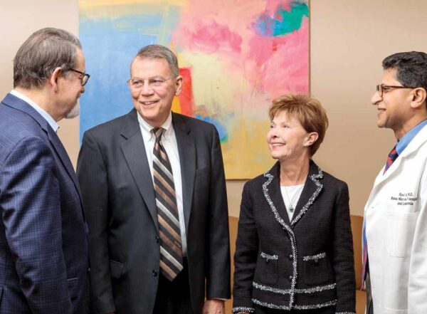 Rodger and Paula Riney, center, greet John DiPersio, MD, PhD, left, and Ravi Vij, MD.