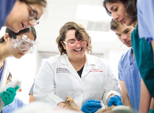 Assistant Professor Kari Allen, PhD, leads first-year students in their final day of dissection in anatomy class.