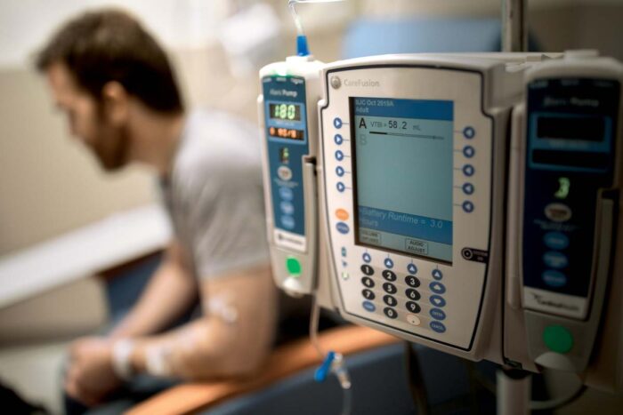 Brian Phillips, a patient with MS, receives an infusion of rituximab, a drug that depletes B cells and has been shown to slow the progression of the disease in certain patients.