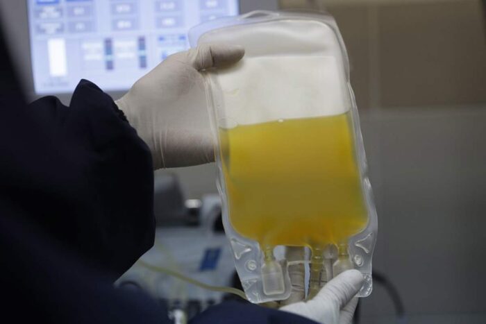 A doctor holds a bag of blood plasma donated by a COVID-19 survivor at at blood bank in La Paz, Bolivia.