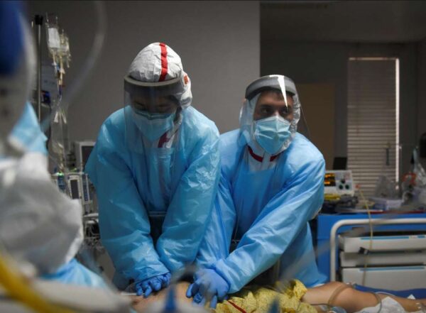 Healthcare personnel perform CPR on a patient inside a coronavirus disease (COVID-19) unit at United Memorial Medical Center