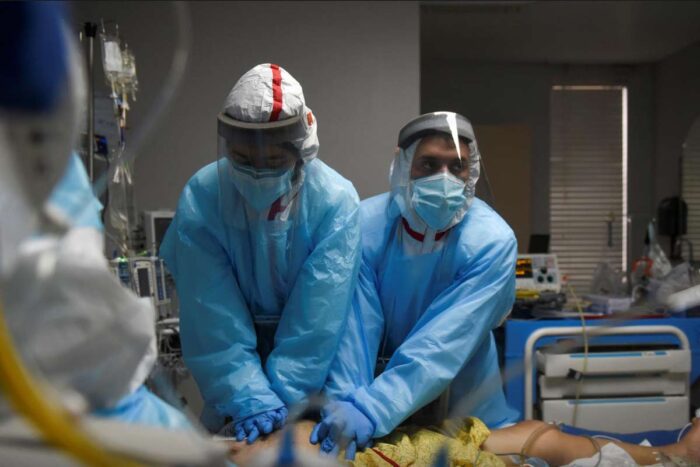 Healthcare personnel perform CPR on a patient inside a coronavirus disease (COVID-19) unit at United Memorial Medical Center