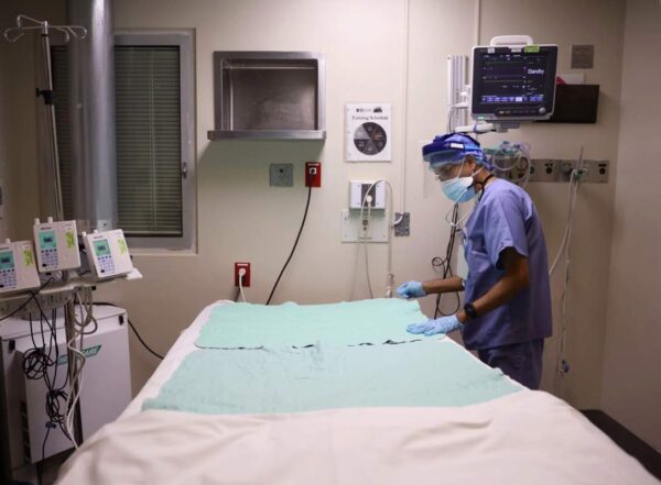 Intensive Care Unit nurse Subramanya Kirugulige prepares a bed for an arriving COVID-19 patient at Roseland Community Hospital in Chicago in December.