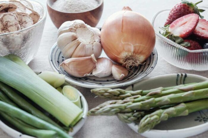 Plates of fresh vegetables including leeks, garlic and asparagus