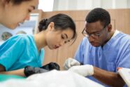 Sarah Chiang, Michelle Cai and Stanley Chibueze participate in their final day of dissection in anatomy class during their first year of medical school in 2018.