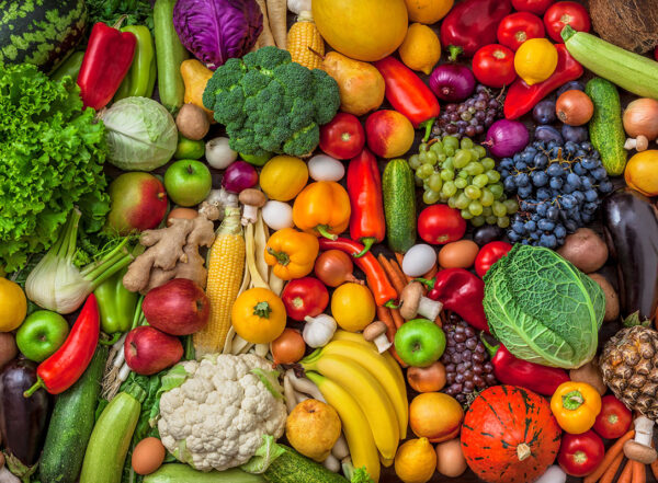 Vegetables and fruits large overhead mix group on colorful background in studio