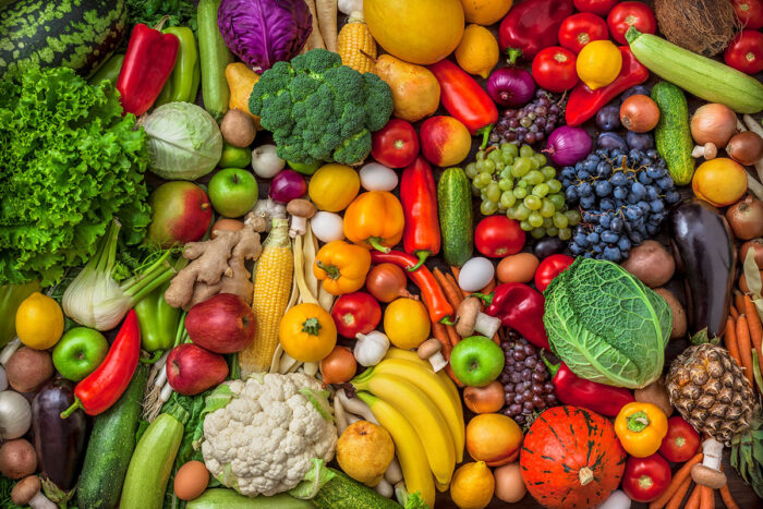 Vegetables and fruits large overhead mix group on colorful background in studio