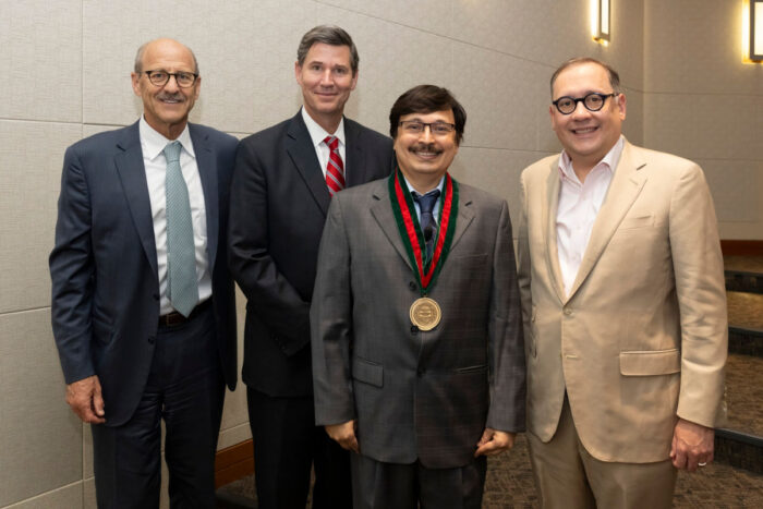 From left, David H. Perlmutter, MD, the George and Carol Bauer Dean of the School of Medicine; Nupam Mahajan, PhD; John A. Olson Jr., MD, PhD, head of the Department of Surgery; and Chancellor Andrew J. Martin.