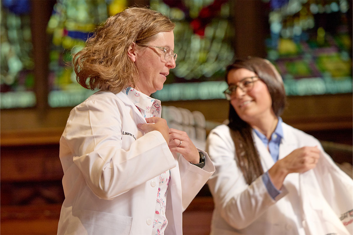 Lauren Everett, president of the new class of medical students at WashU Medicine, receives her white coat at a ceremony at Graham Chapel Oct. 18.