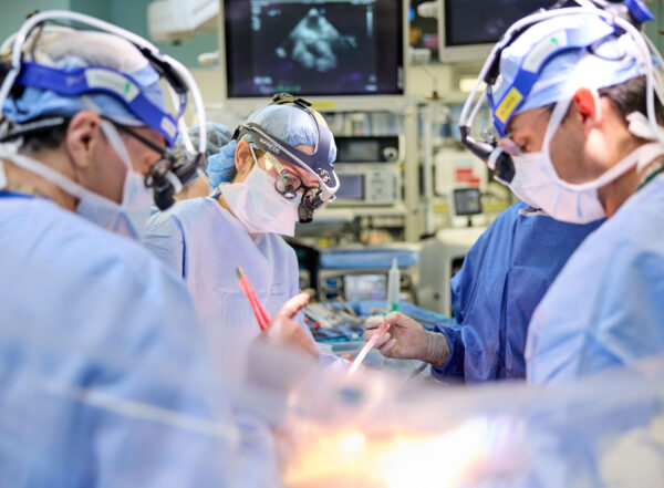 Four doctors in an operating room during an operation.