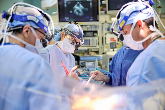 Four doctors in an operating room during an operation.