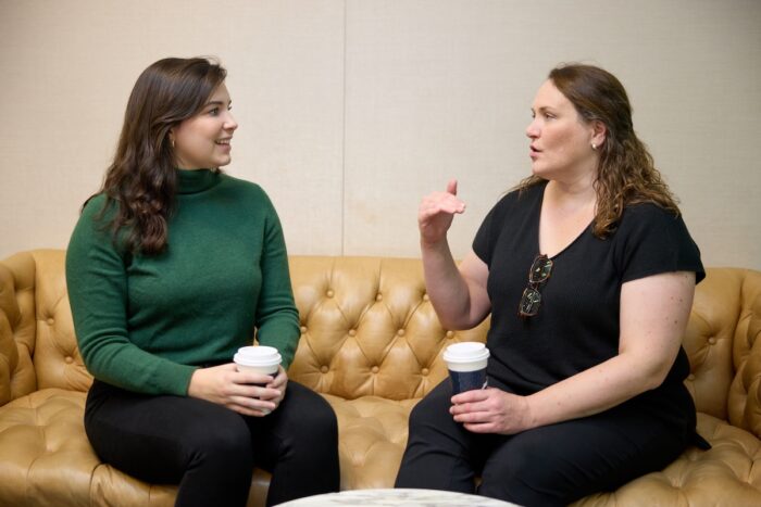 two women talking while having coffee