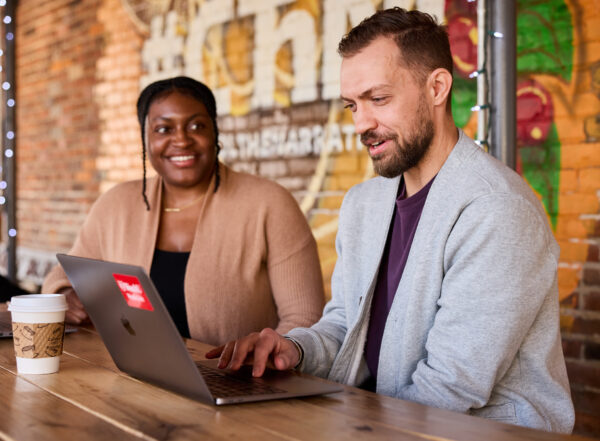 Brittany Jones, Assistant Director of Clinical and Community Integration, Racial Equity Initiatives, at Saint Louis Integrated Health Network, and Brett Maricque, PhD, meet at Northwest Coffee to discuss upcoming projects related to community engagement