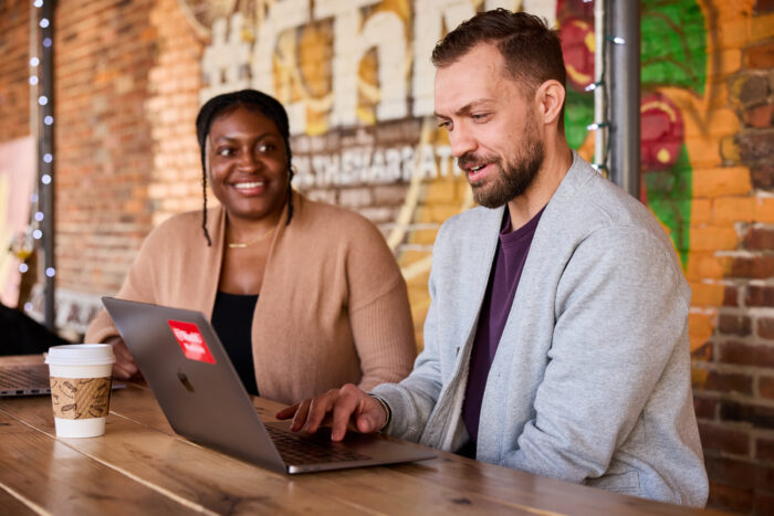 Brittany Jones, Assistant Director of Clinical and Community Integration, Racial Equity Initiatives, at Saint Louis Integrated Health Network, and Brett Maricque, PhD, meet at Northwest Coffee to discuss upcoming projects related to community engagement