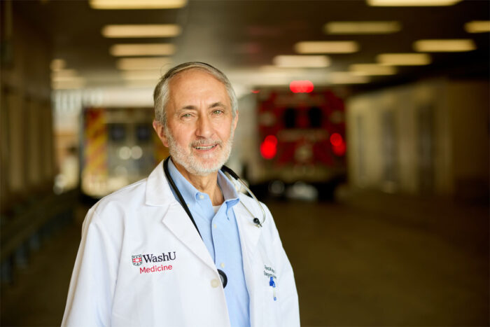 Man in white coat outside emergency room