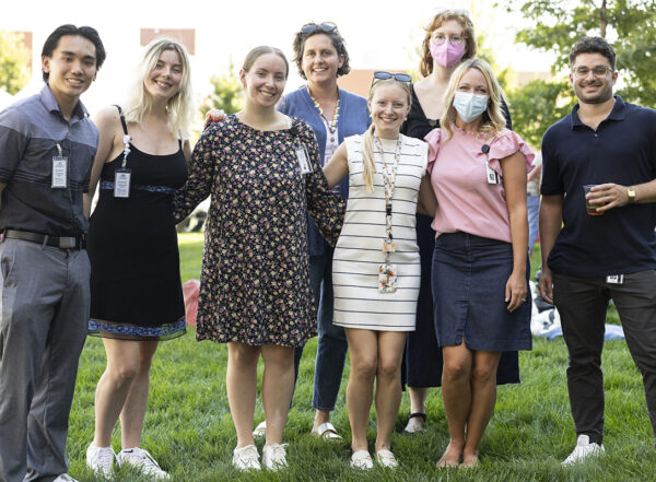 Eight staff members pose for photo