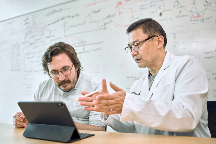 Two scientists looking at a computer.