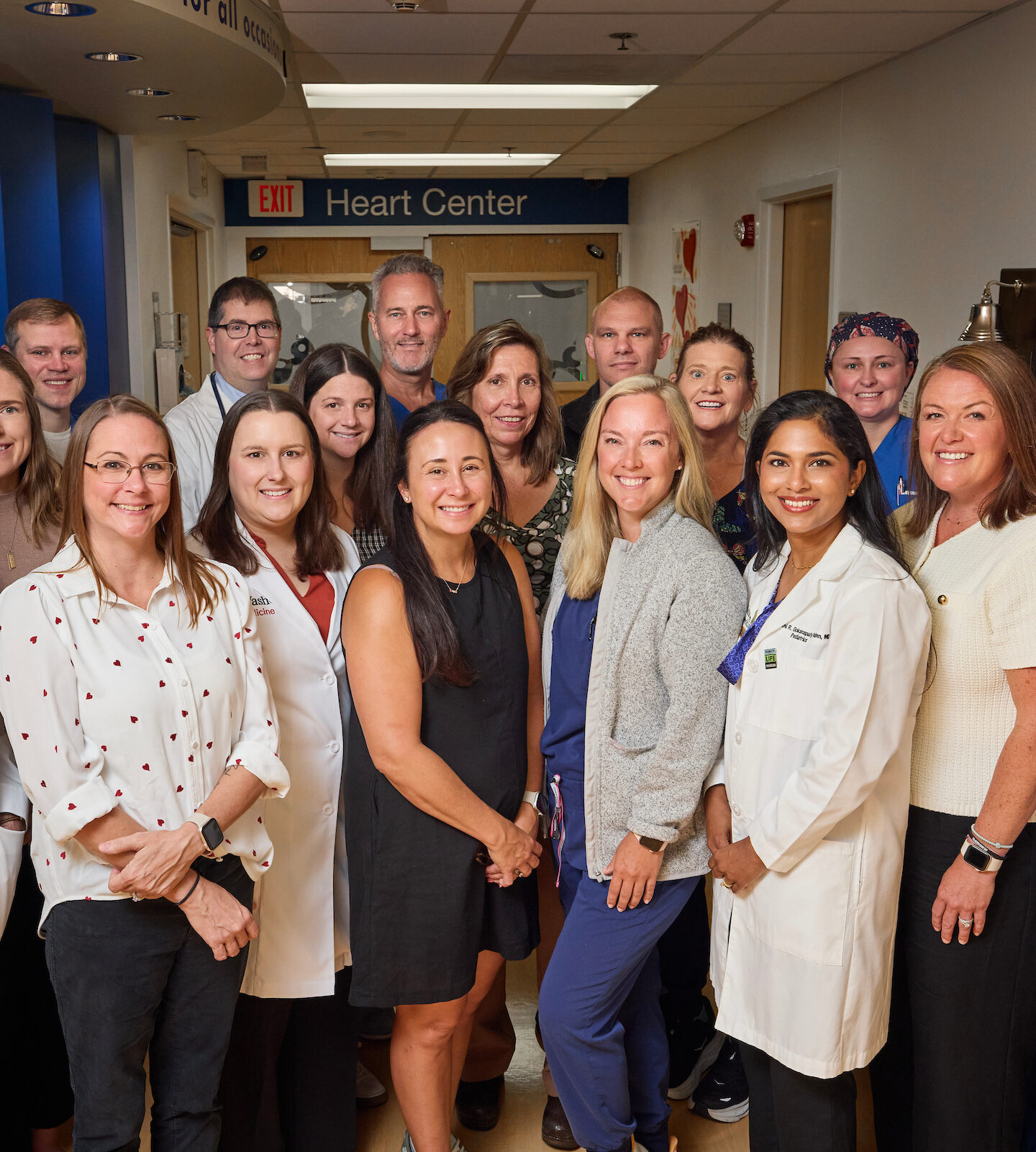 Doctors and other clinical staff posing for photo in hospital hallway