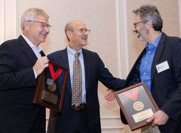 Dr. Milbrant and Dr. DiAntonio accept Deans Medals from Dean Perlmutter