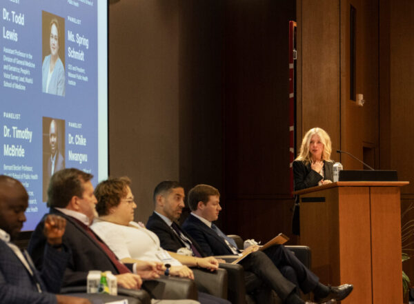 Margaret Kruk (right) introduces panelists for a discussion on challenges facing health systems