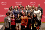 Group of WashU faculty, staff and students pose in front of WashU Medicine sign
