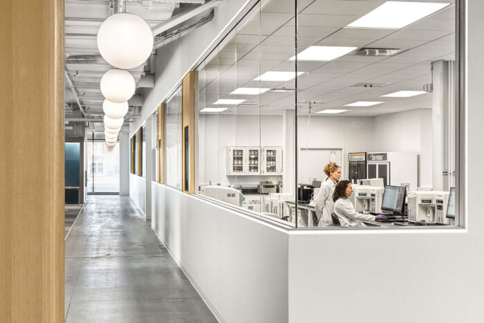 Photo of lab with two scientists at a computer.