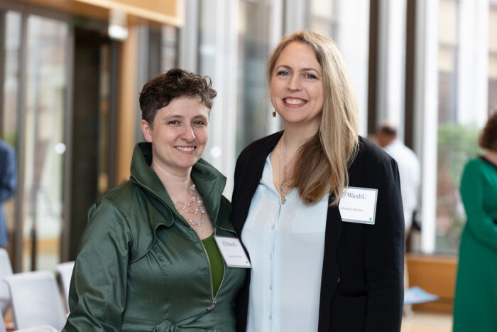 Two women smile and pose for a photo.