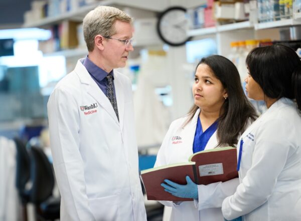 Timothy Miller, MD, PhD, collaborating in his lab
