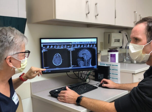 Patient and doctor looking at a medical scan.