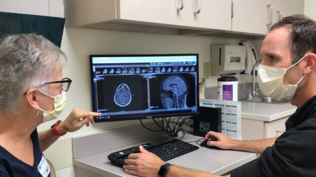 Patient and doctor looking at a medical scan.