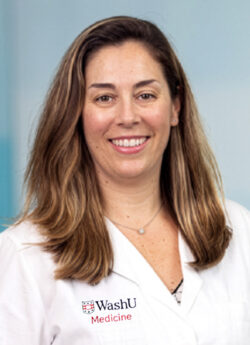 Headshot of female physician/educator who is smiling and wearing a white coat