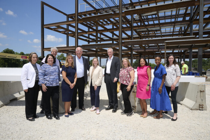 Group of people standing in front of building under construction