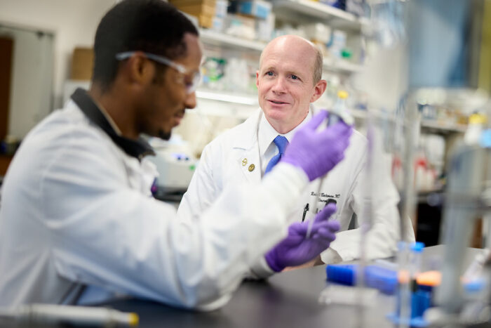 Randall Bateman in his lab with another scientist