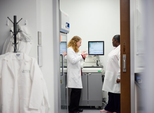 Suzanne Schindler, MD, PhD, reviews data from an assay analyzer with clinical lab assistant Alexis Montgomery regarding Alzheimer’s disease research at the Fort Labs at the Neuroscience Research Building on February 18, 2026.