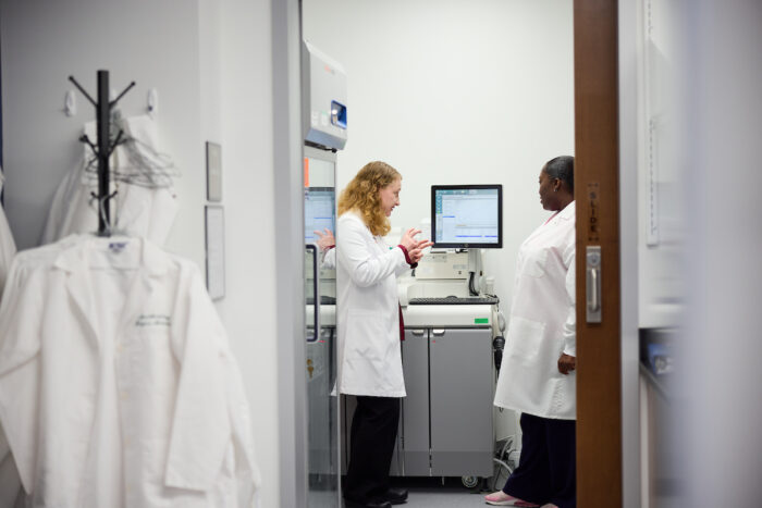 Suzanne Schindler, MD, PhD, reviews data from an assay analyzer with clinical lab assistant Alexis Montgomery regarding Alzheimer’s disease research at the Fort Labs at the Neuroscience Research Building on February 18, 2026.