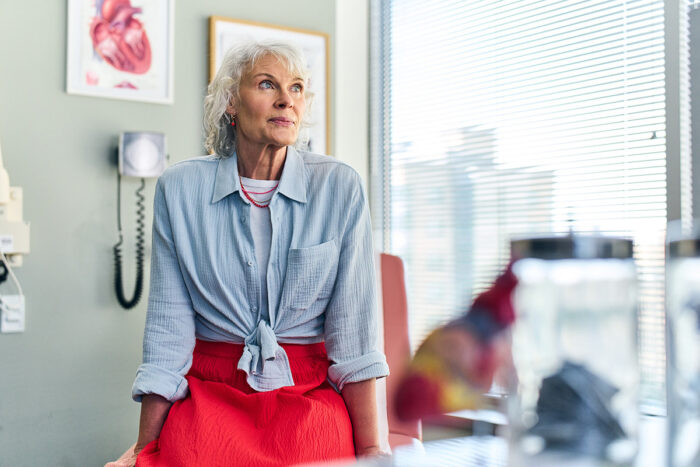 Healthy, elderly woman smiling in doctor's office.